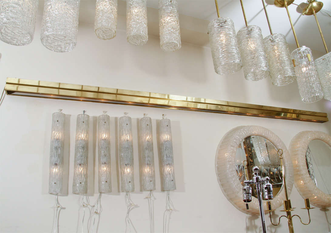 Long brass horizontal wall mounted light fixture